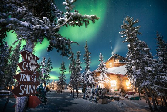 A lodge and cabins on the shore of a frozen lake at Blachford Lake Lodge, Northwest Territories, Canada