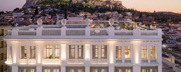 A neoclassical facade and terrace looking towards the Acropolis at The Dolli at Acropolis, Athens, Greece