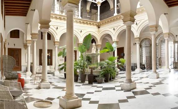 A columned marble courtyard inside an eighteenth-century palace at Hotel Palacio de Villapanés, Seville, Spain