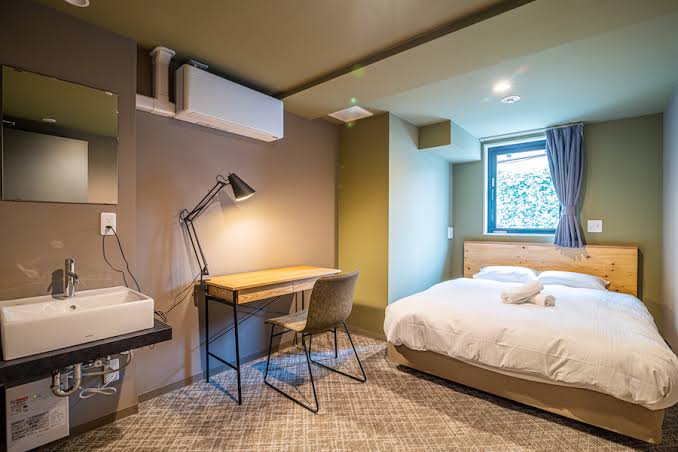Curtained cabin berths and a shared basement room at Wise Owl Hostels River, Tokyo, Japan