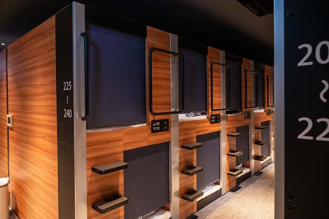 A corridor of cabin berths lit evenly along both sides